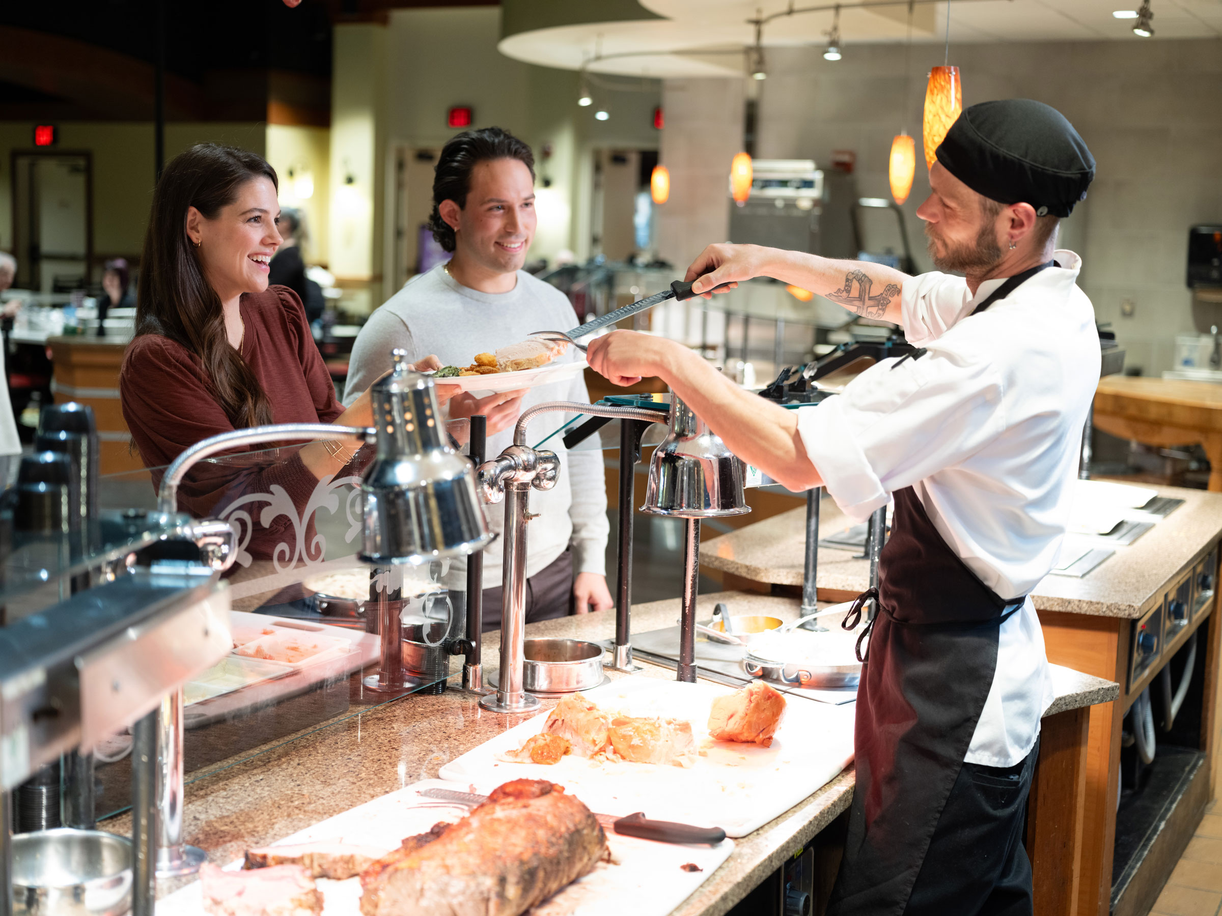 Chef at carving station serving guests