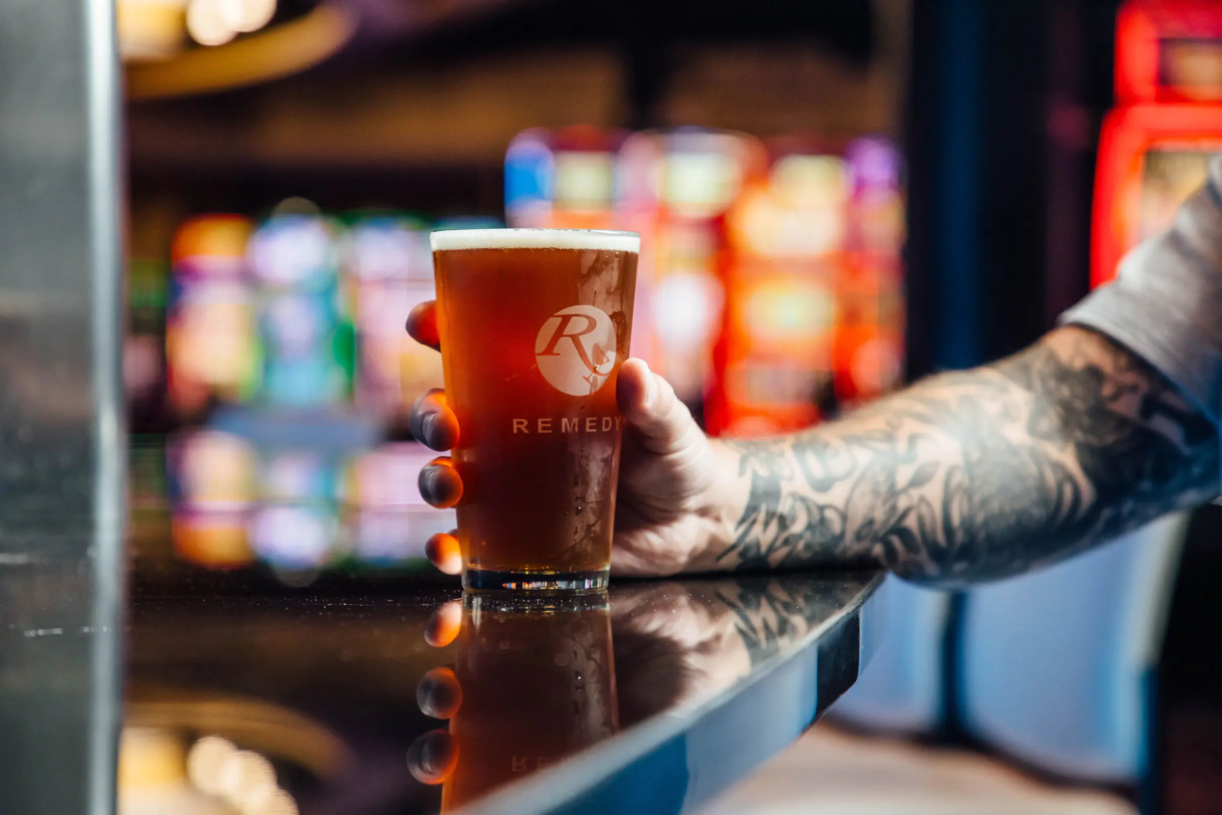 Gentleman holding Remedy Bar glass of beer