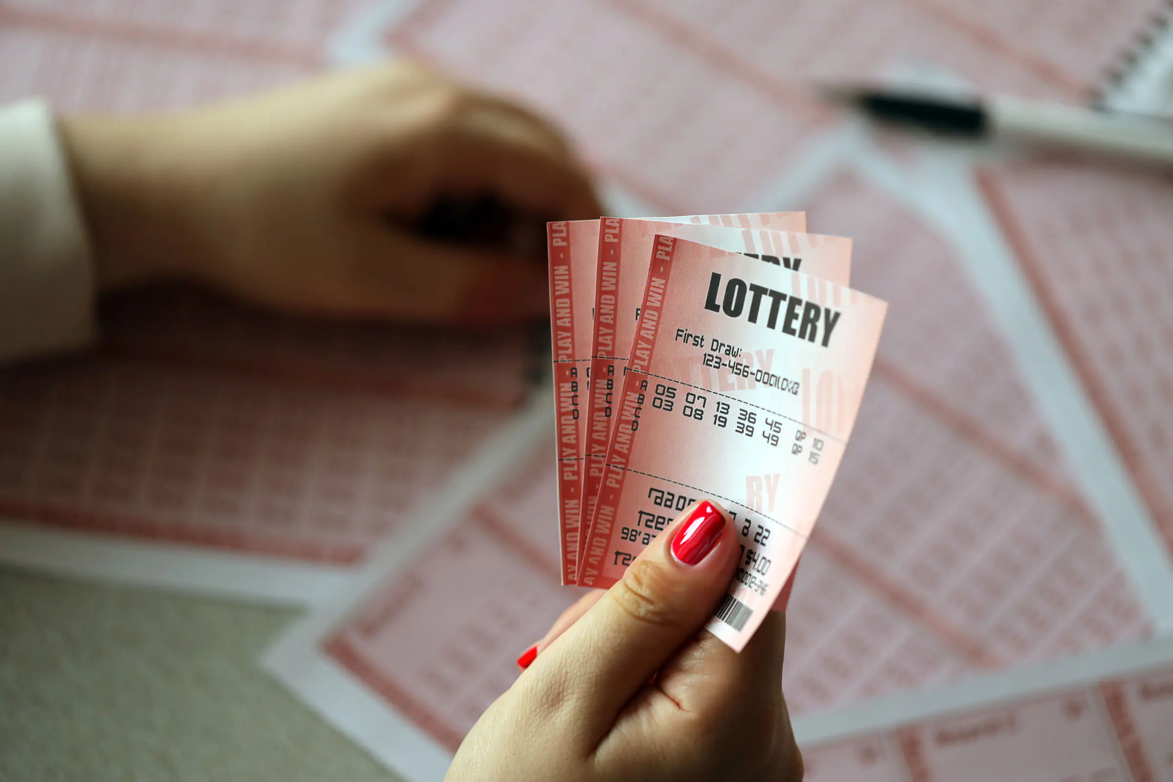 Individual holding lottery tickets