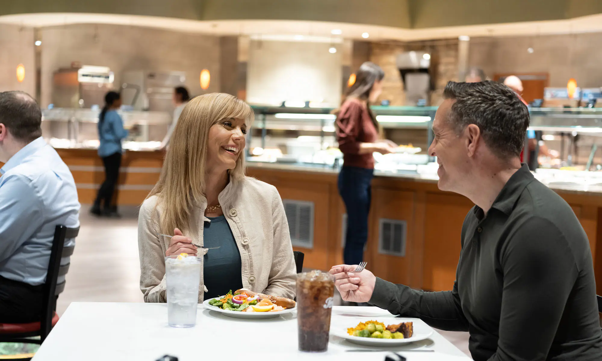 Couple enjoying meal from buffet