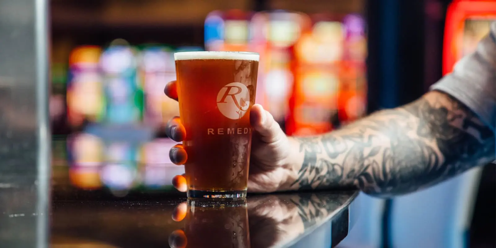 Man holding beer at the Remedy Bar