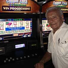 Jackpot winner Jeffrey from Rochester in front of his winning gaming machine at Finger Lakes.